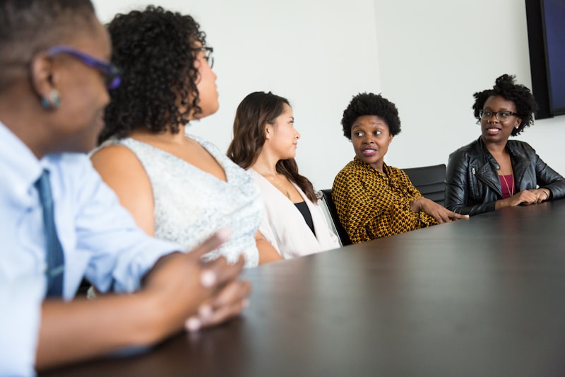 A diverse group of experts discussing cybersecurity strategies around a conference table